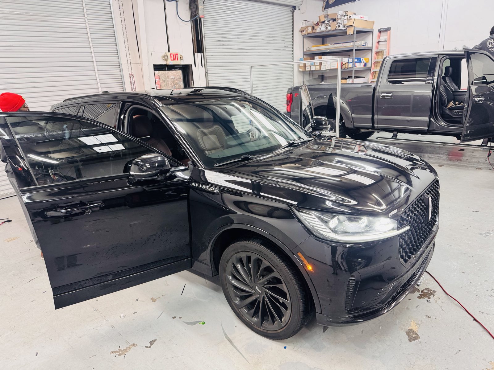 Black Lincoln Aviator with the doors open for window tint inside The Tint Guy
