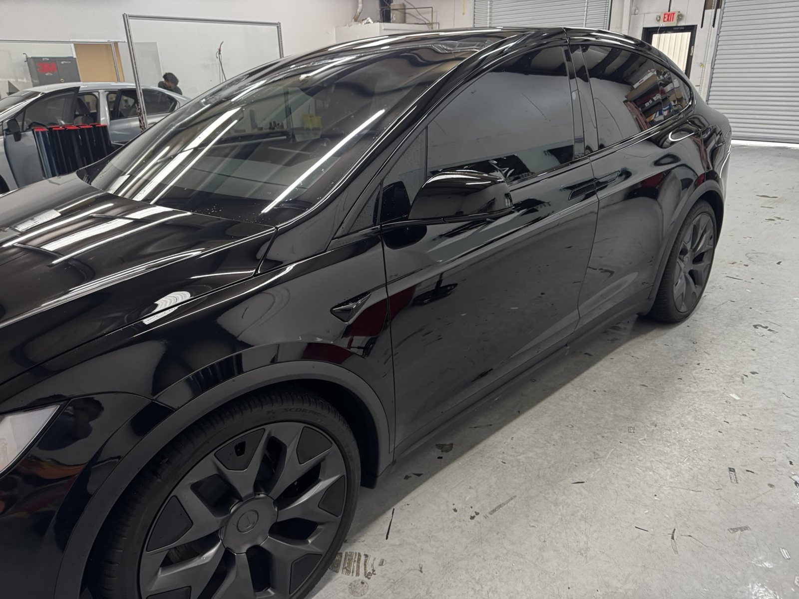 Black Tesla Model X inside The Tint Guy install bay