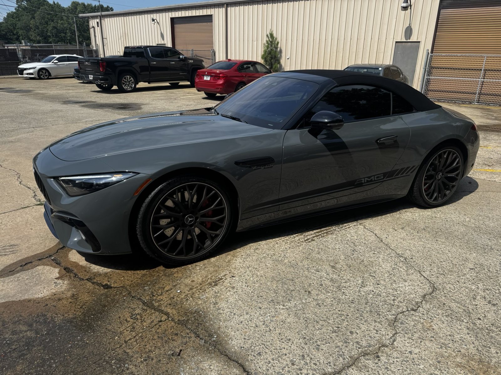 Gray Mercedes-AMG SL parked outside The Tint Guy shop