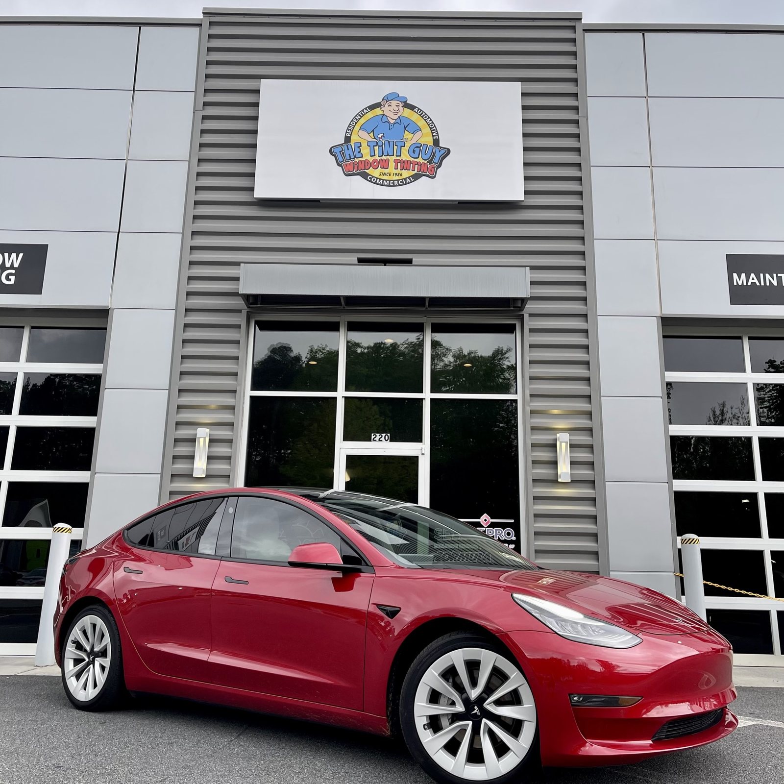 Red Tesla Model 3 outside The Tint Guy Kennesaw shop