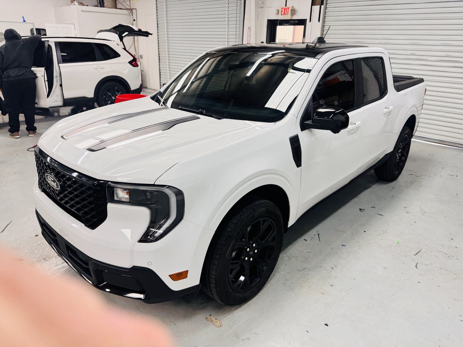 White Ford Maverick inside The Tint Guy shop