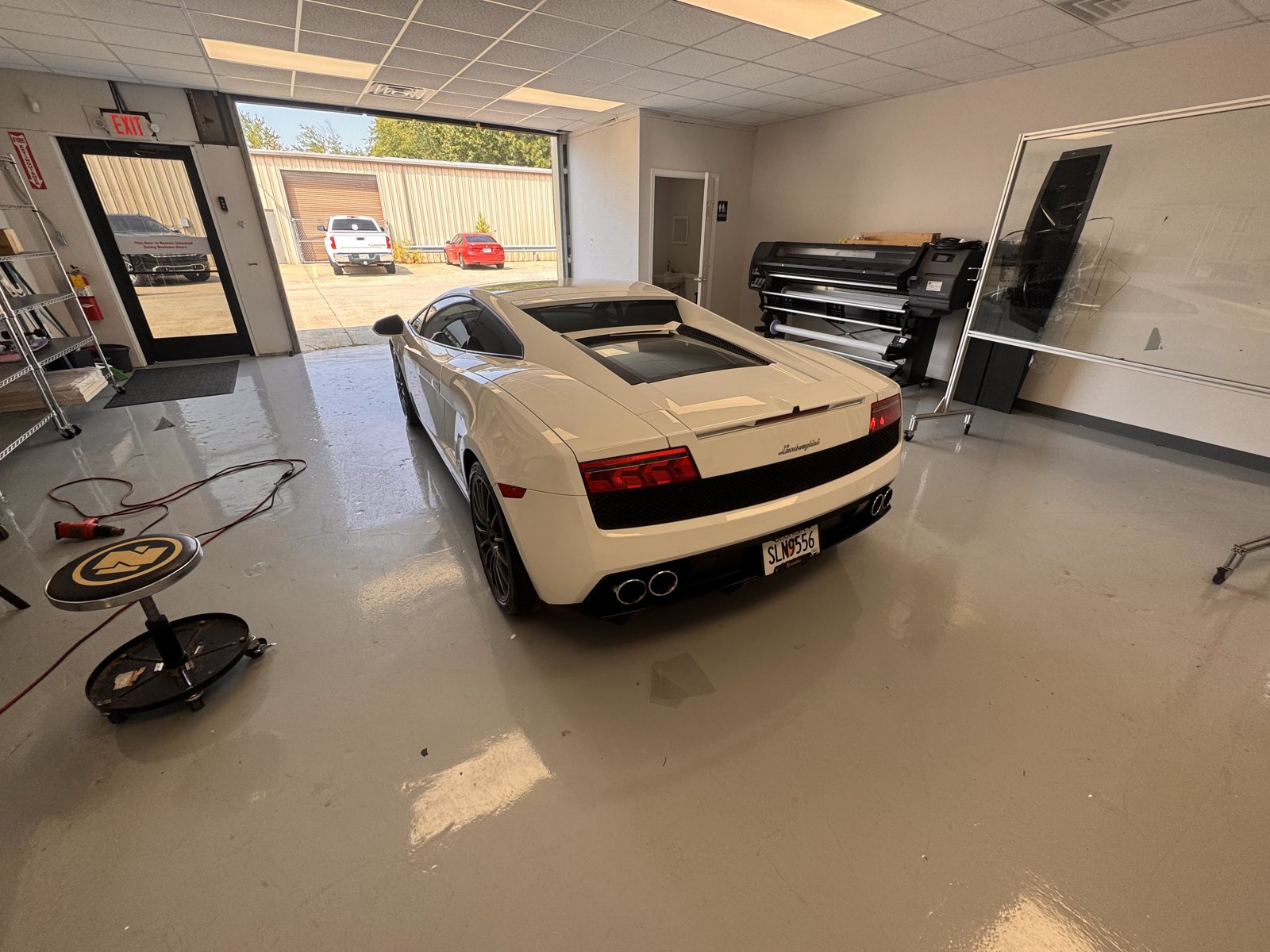 White Lamborghini inside The Tint Guy shop